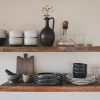 ceramic bowls on brown wooden shelves