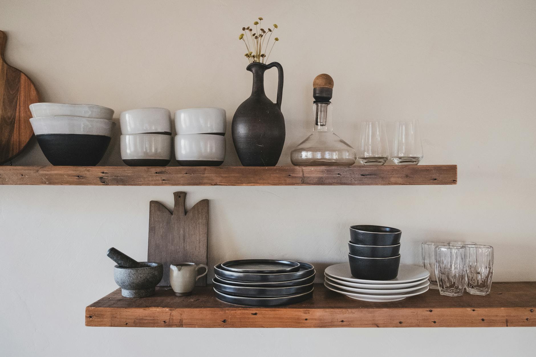 ceramic bowls on brown wooden shelves